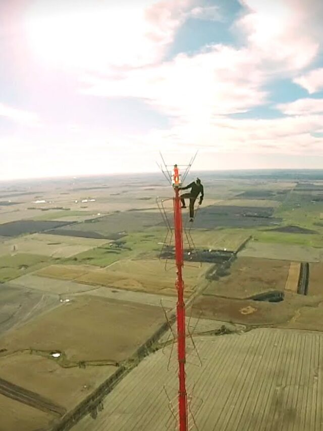 Man climbs California radio tower with “Free Billie Eilish” sign.